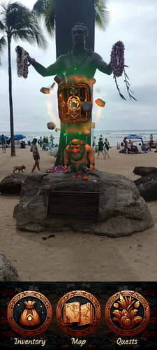 An AR chest glowing at the base of the Duke Kahanamoku statue on Waikiki beach
